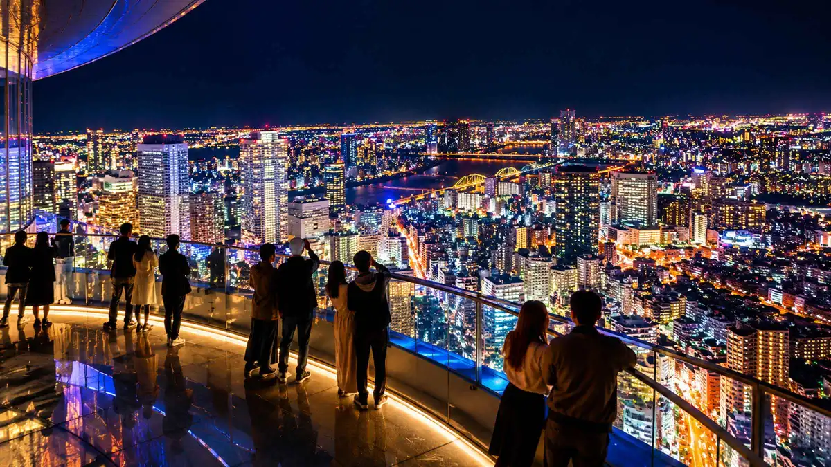 Osaka skyline glowing at dusk from the Umeda Sky Building rooftop on an evening neon tour, Osaka Japan